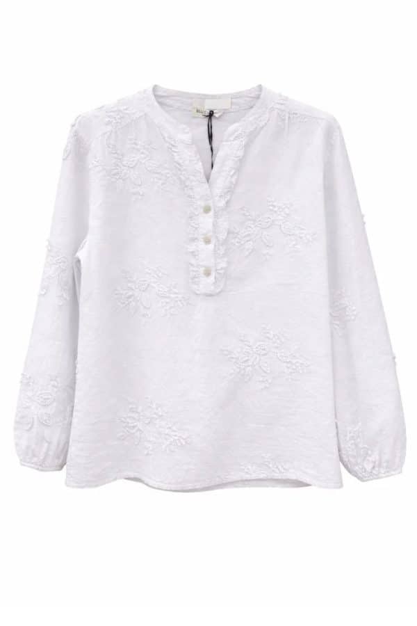 Vit blus med blomapplikationer