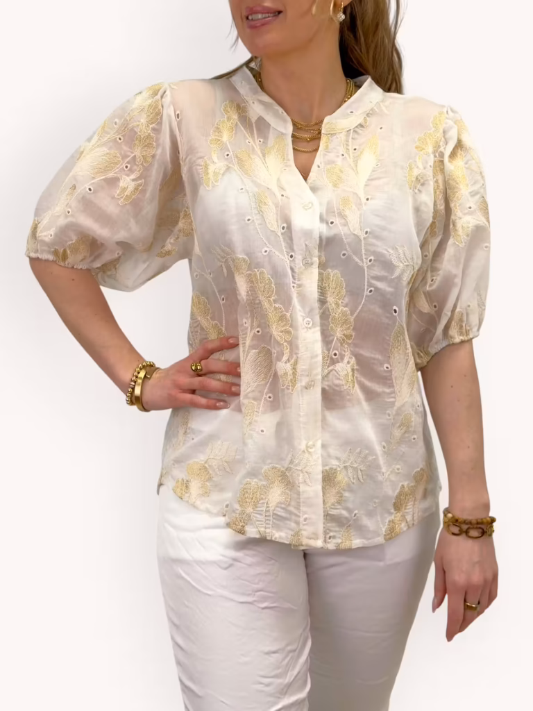 Vit blus med blommor i guld