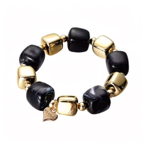 Coolt armband med fräck design med svarta och guldiga stenar